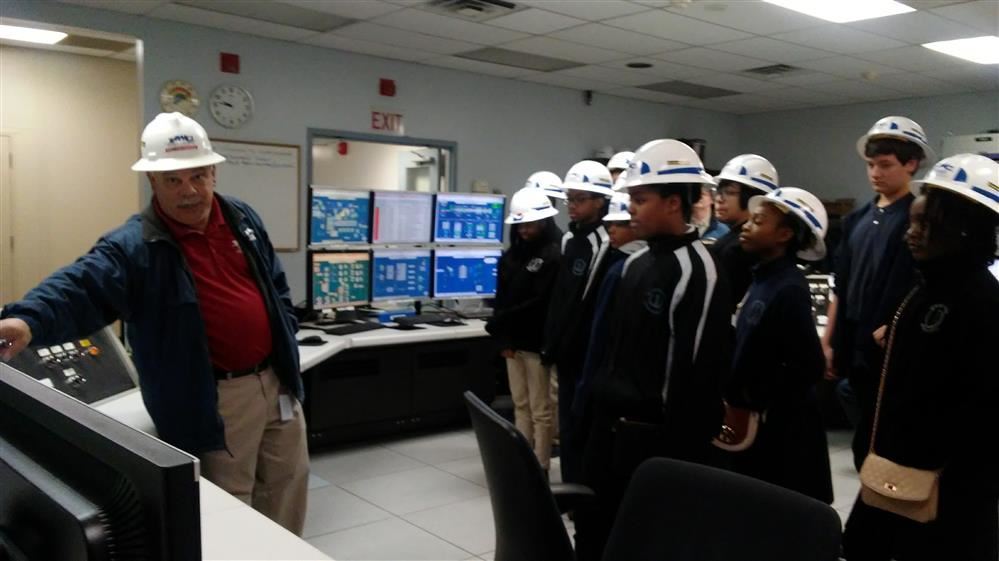  A group of students standing in hard hats at PWC's generation plant.