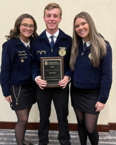 Three students pose with a plaque involved in the FFA CTSO 