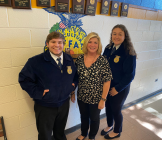 Two students pose for photo with CTE teacher