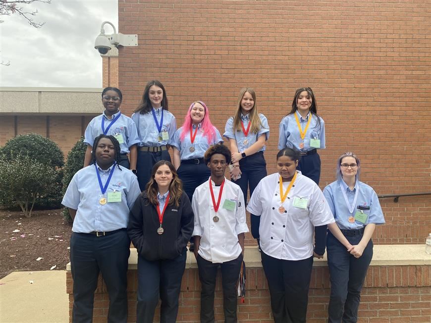 Culinary students posing for photo after receiving awards from the Skills USA competition