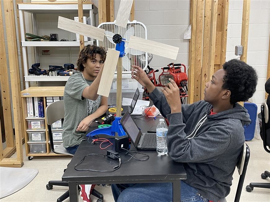 Two students working on a wind turbine design