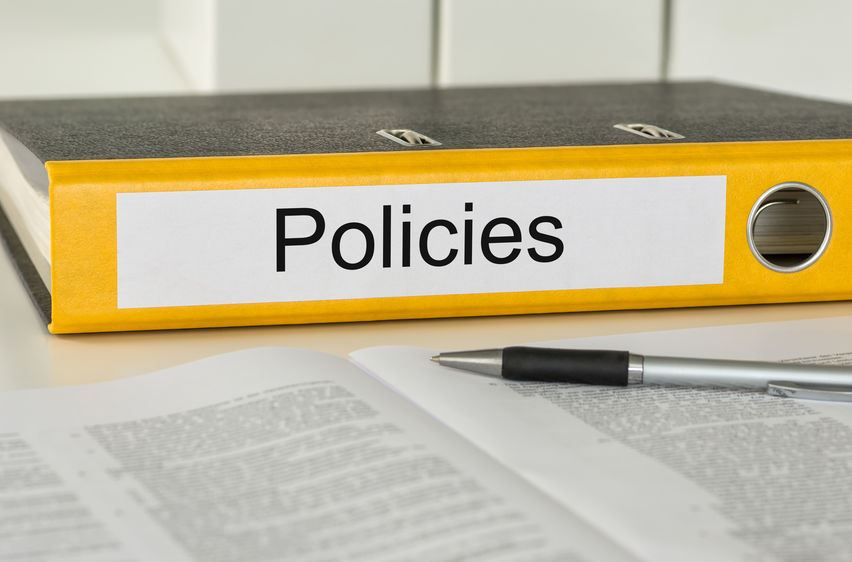 Notebook with the word policies on the spine.