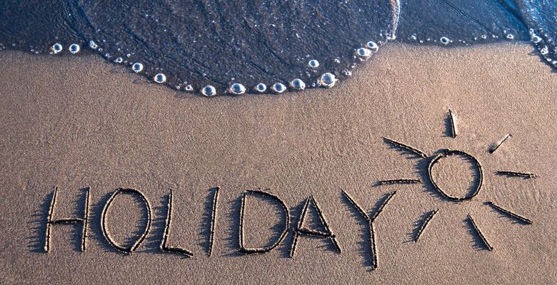  holiday written in sand
