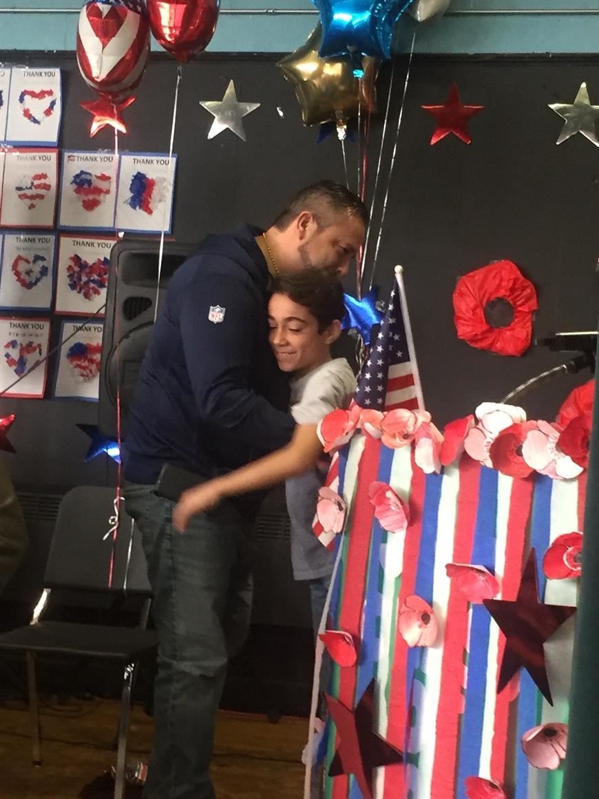  student hugging a veteran