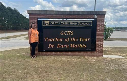 Dr. Mathis with her GCHS Teacher of the Year Marquee sign